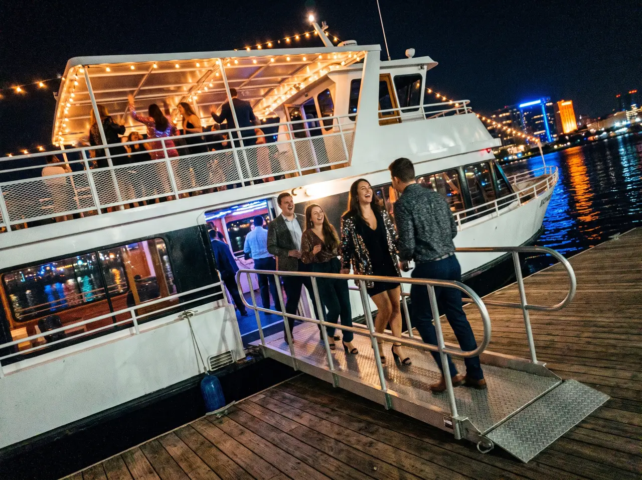 Large Premium yacht hosting a party with guests on two decks on the Bosphorus